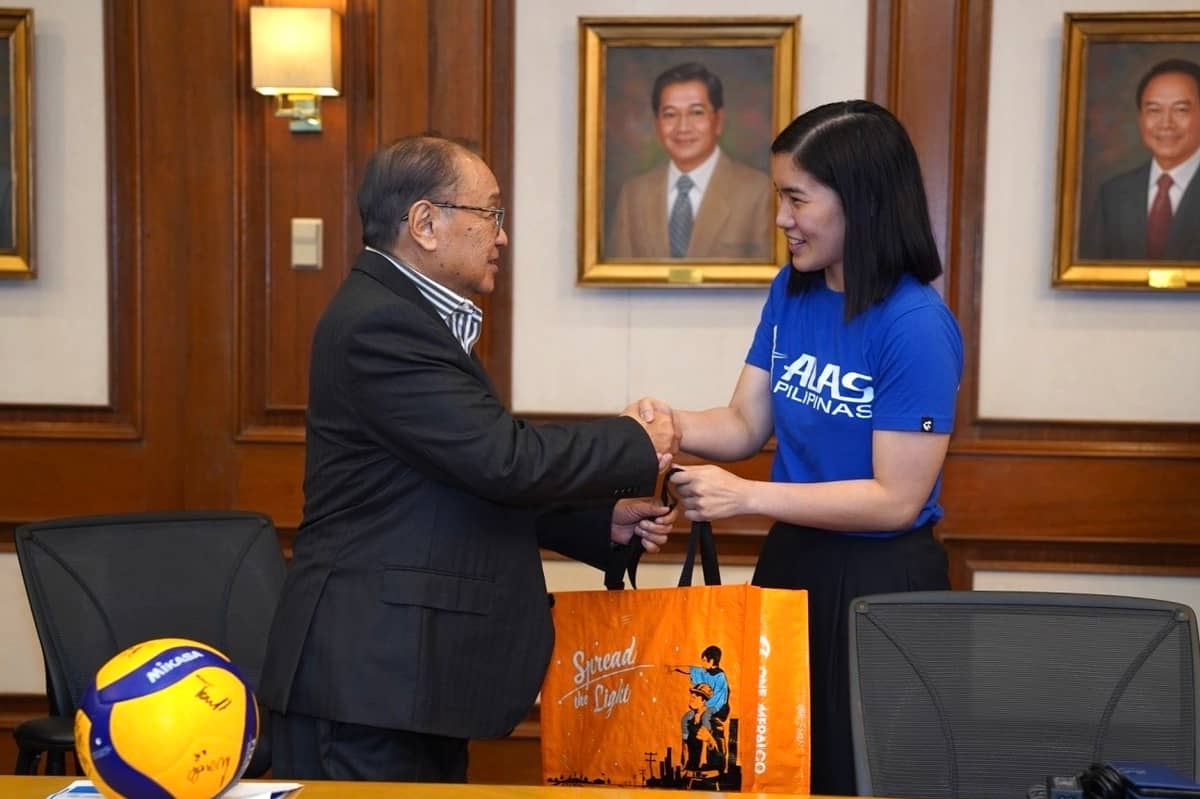 Meralco Chairman and Chief Executive Officer Manuel V. Pangilinan (left) personally hands out a token to Alas Pilipinas women’s volleyball team captain Jia de Guzman to symbolize the company’s full support to the national team during a courtesy call at Meralco compound in Pasig City.